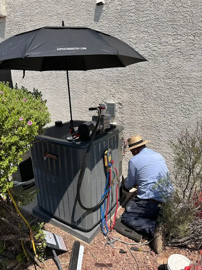 HVAC technician performing outdoor AC maintenance in Palm Tree
